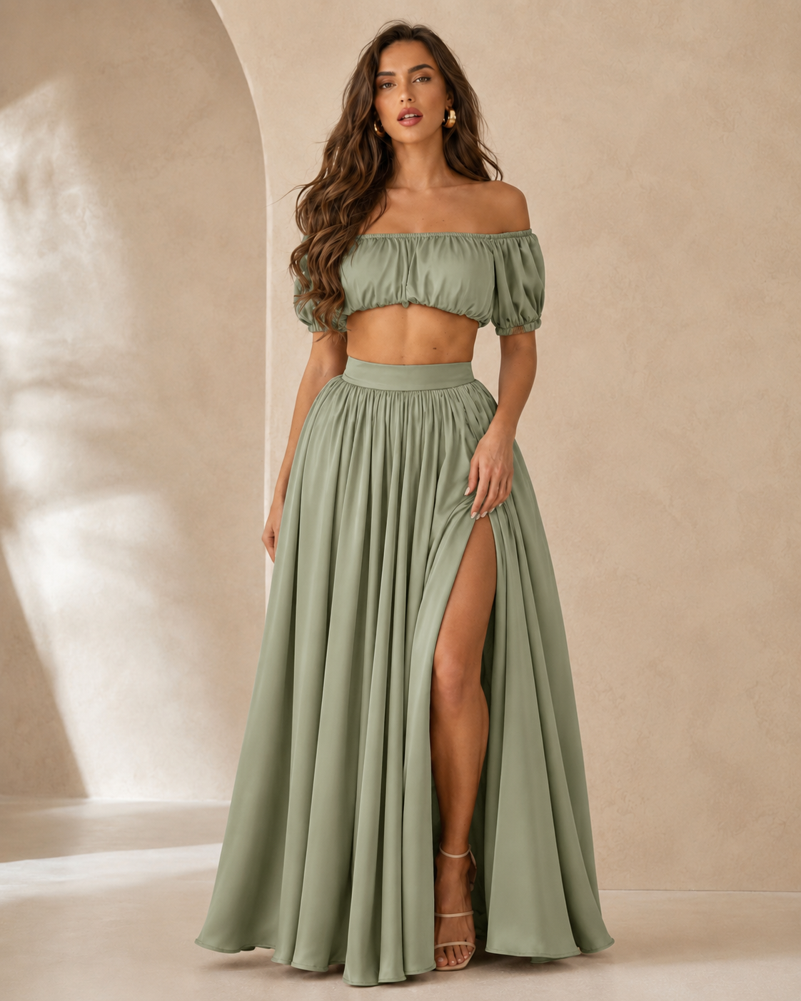 Woman wearing a sage off shoulder crop top and high slit maxi skirt set front view