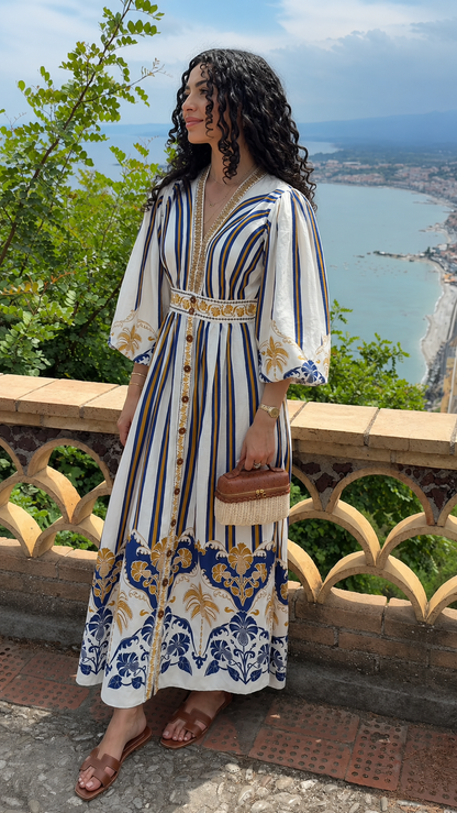 Front view of white bohemian print V-neck maxi dress with blue and gold border details