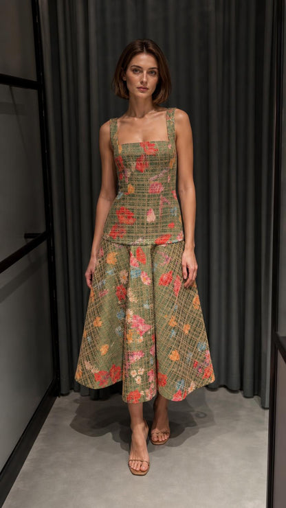 Front view of woman wearing green floral tweed top and midi skirt set