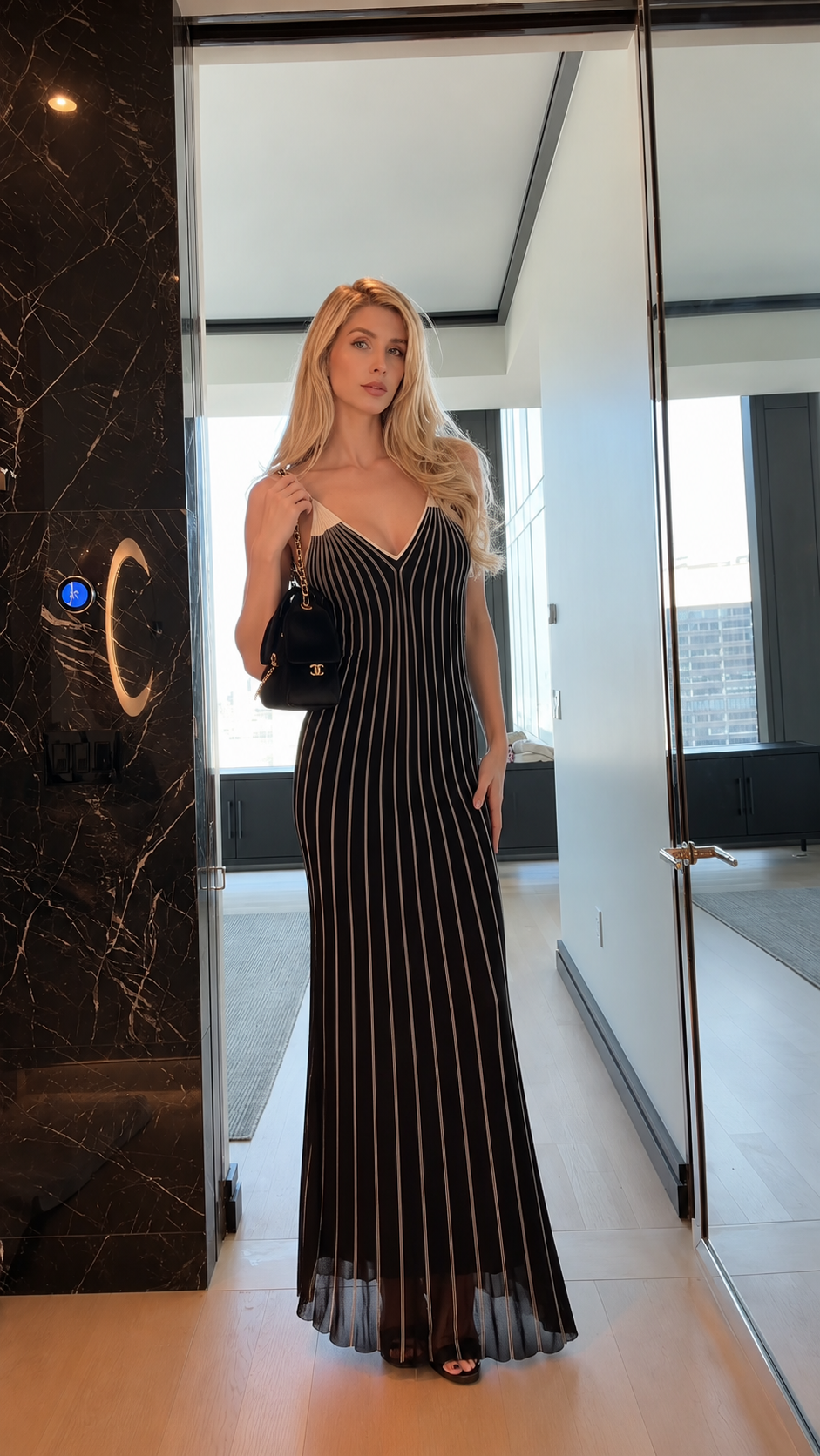 Front view of black striped spaghetti strap mermaid maxi dress with V-neckline
