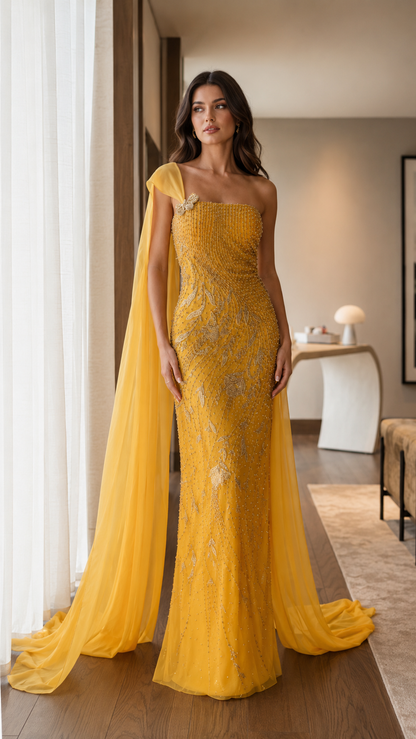Front view of marigold one-shoulder mermaid evening gown with flowing cape
