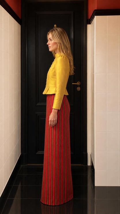 Side profile view of yellow jacket and striped maxi skirt set