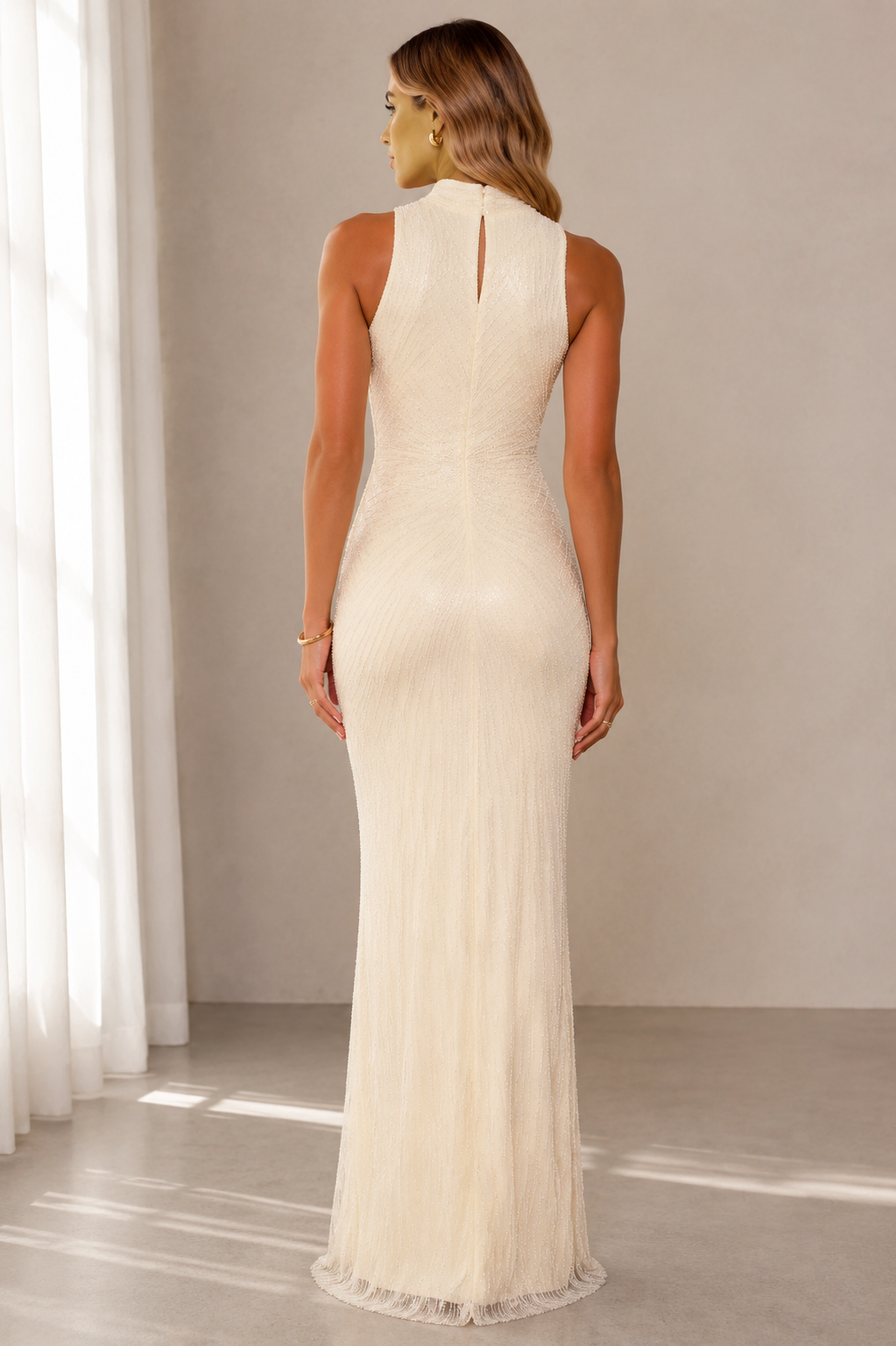 Back view of ivory sleeveless textured maxi gown with keyhole detail