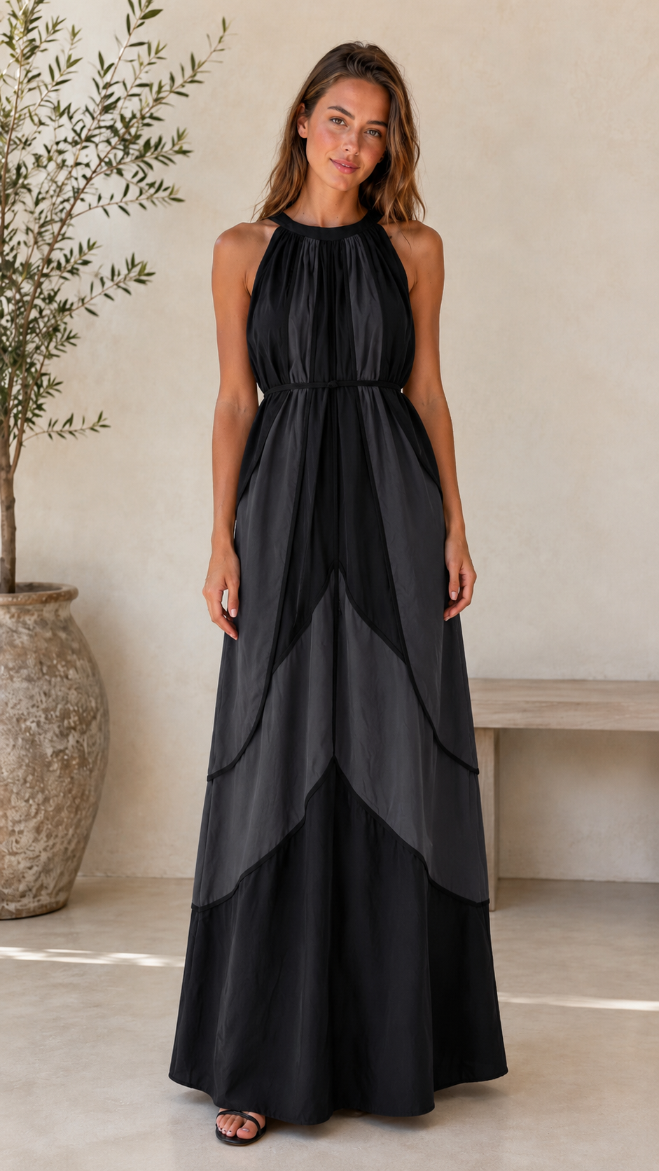 Front view of black halter maxi dress with layered contrast panel design