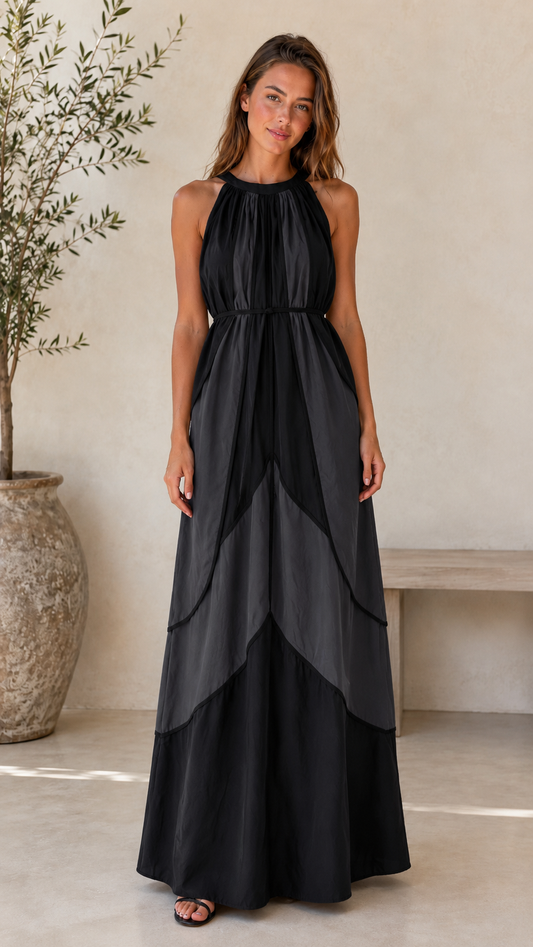 Front view of black halter maxi dress with layered contrast panel design