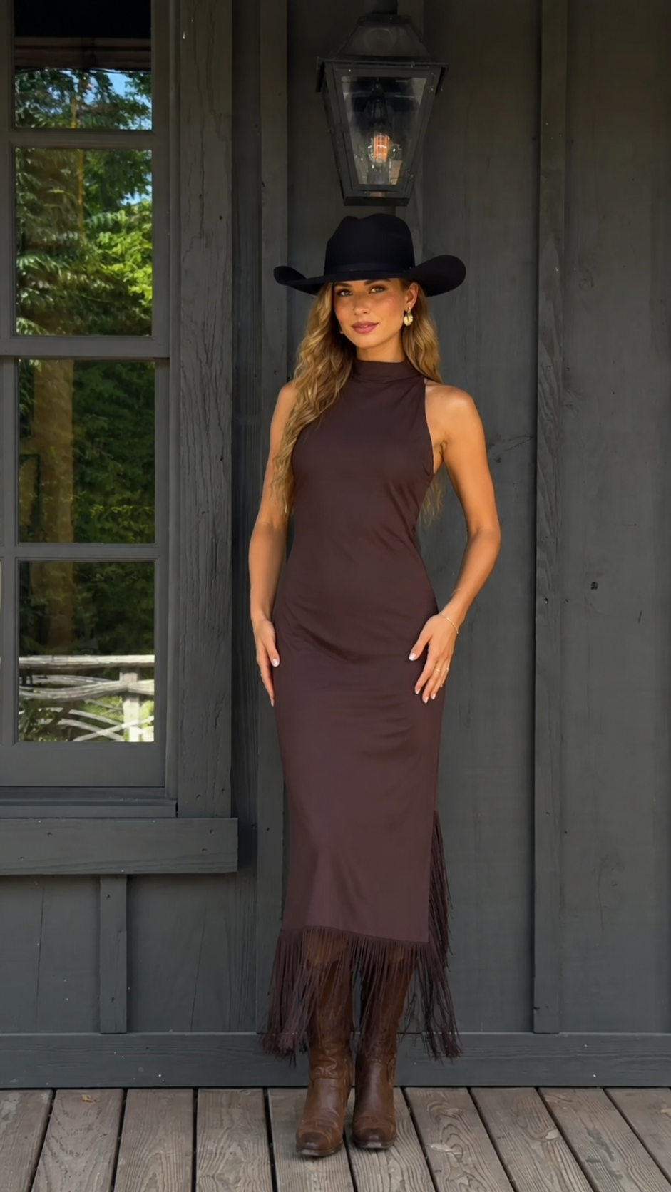 Front view of chocolate brown sleeveless mock neck fringe hem maxi dress