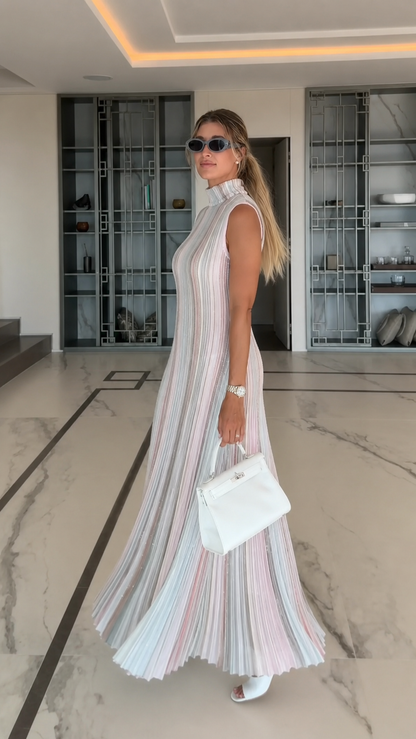 Side view of pastel multi pleated sleeveless maxi dress with flowing hem