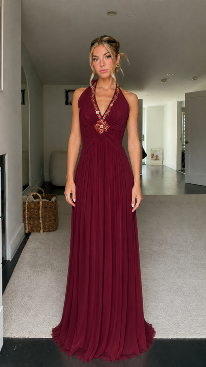 Front view of burgundy beaded halter pleated maxi dress
