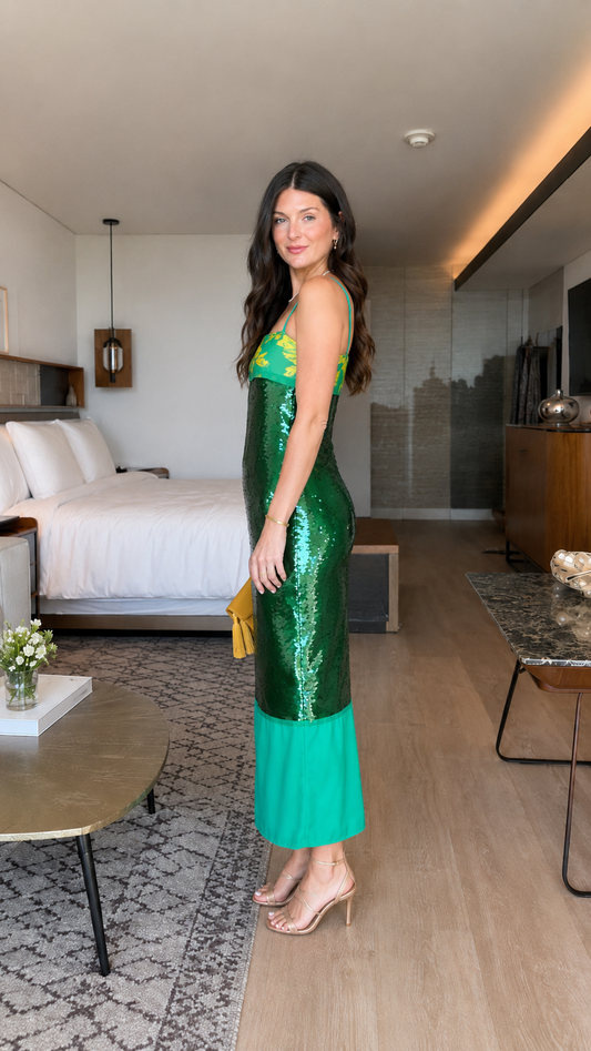 Side view of emerald green sequin slip midi dress with slim straps and midi length