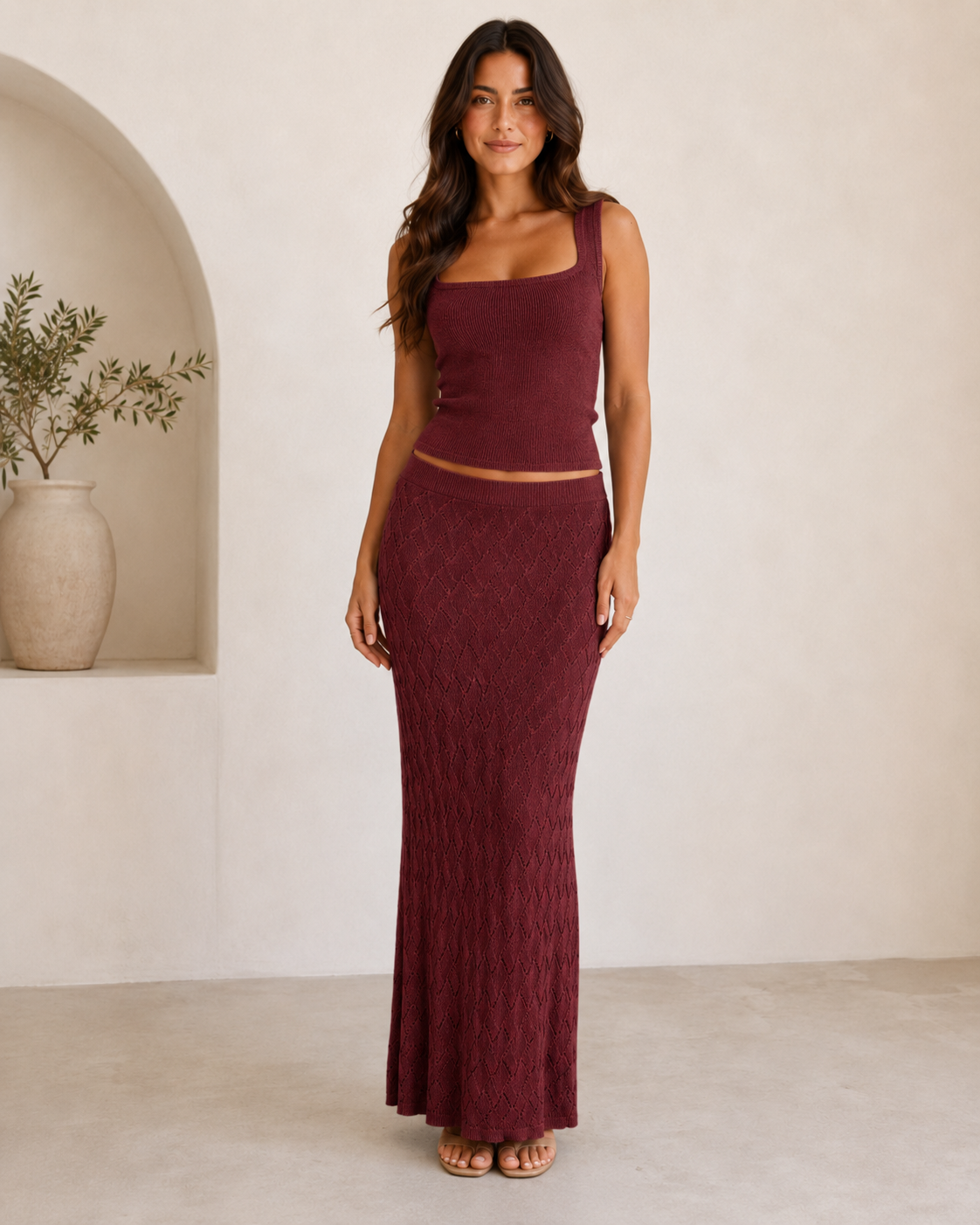 Woman wearing a burgundy square neck knit tank top and textured maxi skirt set