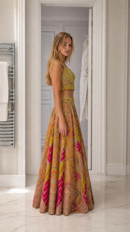Side profile view of woman in yellow embroidered lehenga ensemble