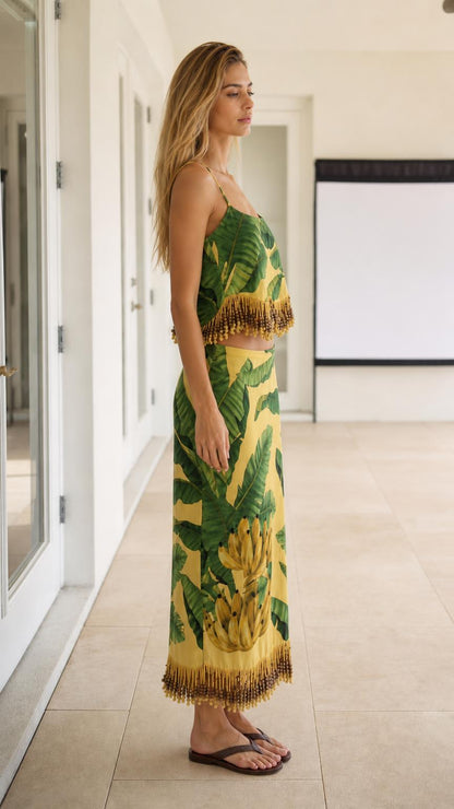 Side profile view of model wearing the yellow tropical two-piece skirt set