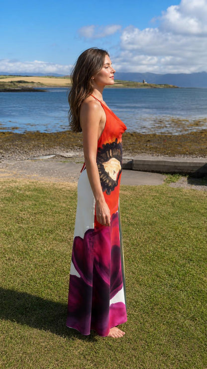 Side profile of red floral halter maxi dress