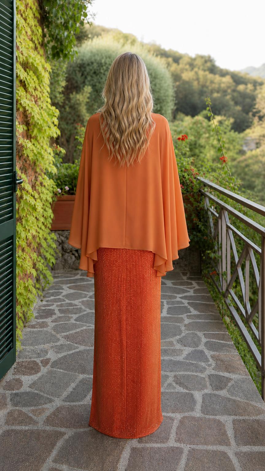 Back view of orange cape overlay maxi dress