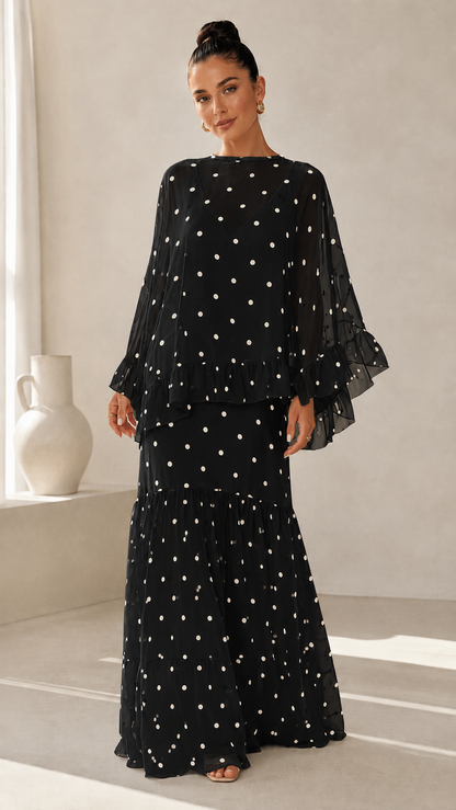 Black polka dot maxi dress with sheer long sleeves and ruffle hem
