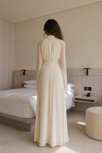 Back view of woman wearing cream pleated maxi dress