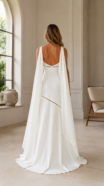 Back view of white formal gown with low back and long cape panels