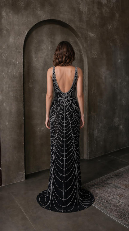 Back view of black beaded evening gown showing scoop back