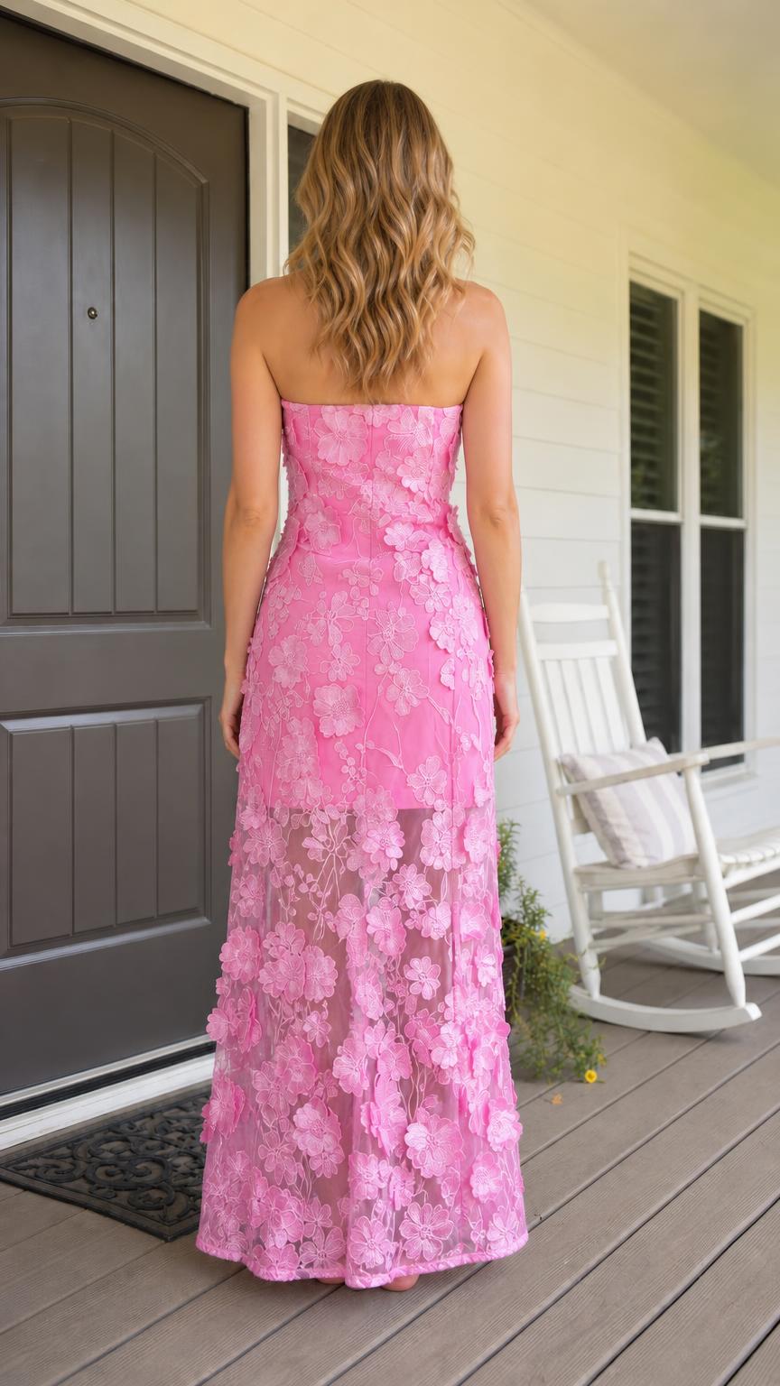 Back view of model wearing pink 3D floral strapless maxi dress