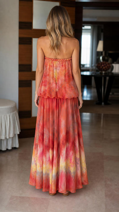 Model wearing orange tie-dye strapless maxi dress from back
