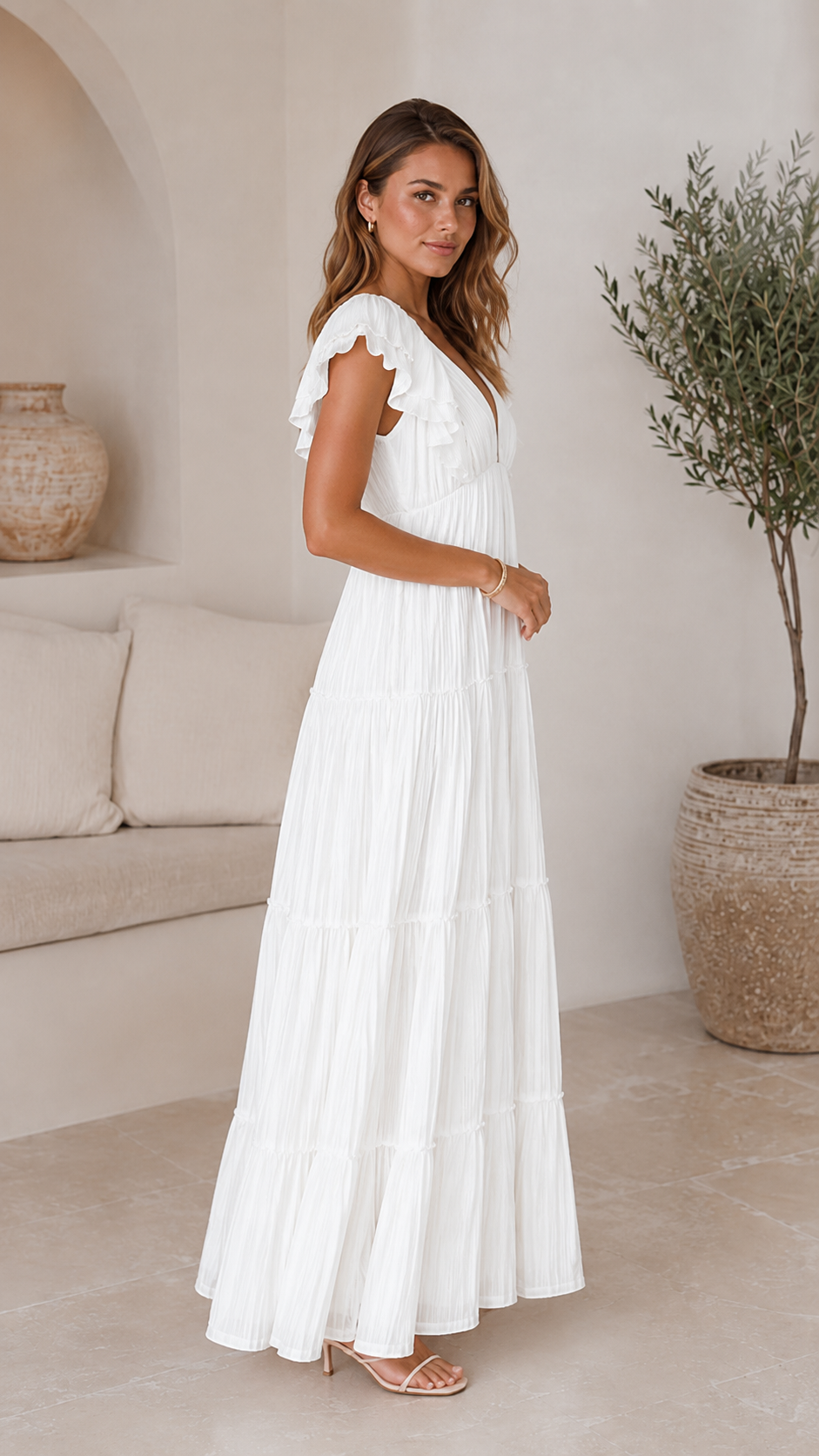 Side view of white flutter sleeve pleated tiered maxi dress