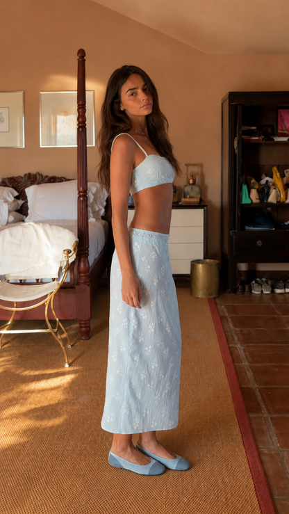 Side view of powder blue spaghetti-strap crop top and embroidered maxi skirt