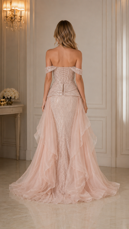 Back view of blush pink fitted evening gown with corset-style back and flowing train