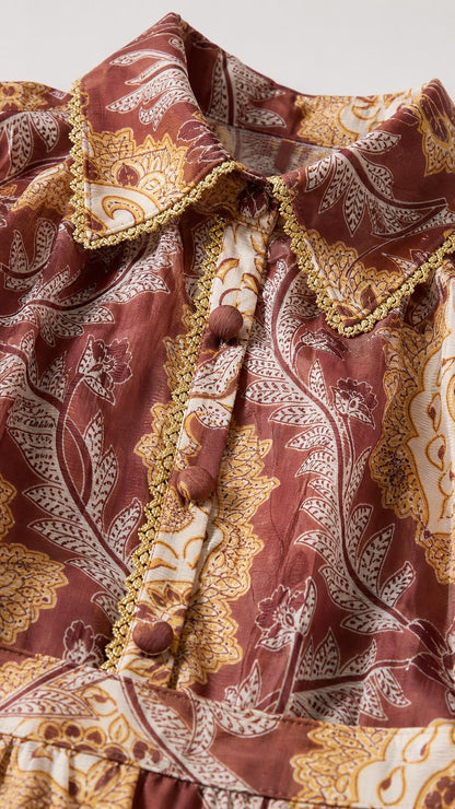 Close-up detail of shirt collar, braided trim, and button placket
