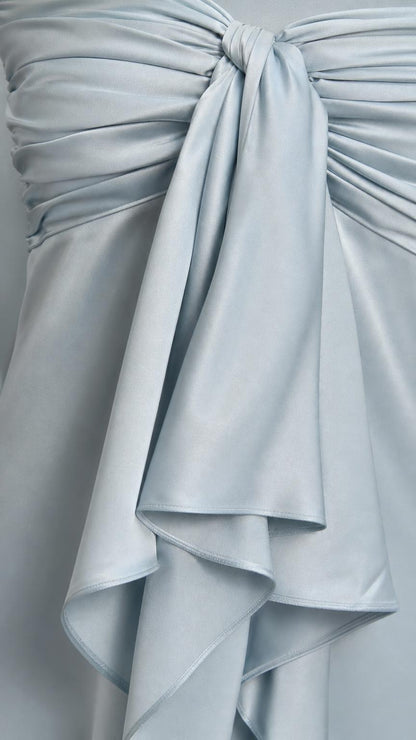 Close-up detail of the bodice bow and satin ruffles