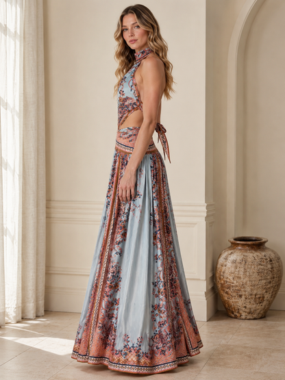 Side view of sky blue printed halter maxi dress showing cutout waist and full skirt