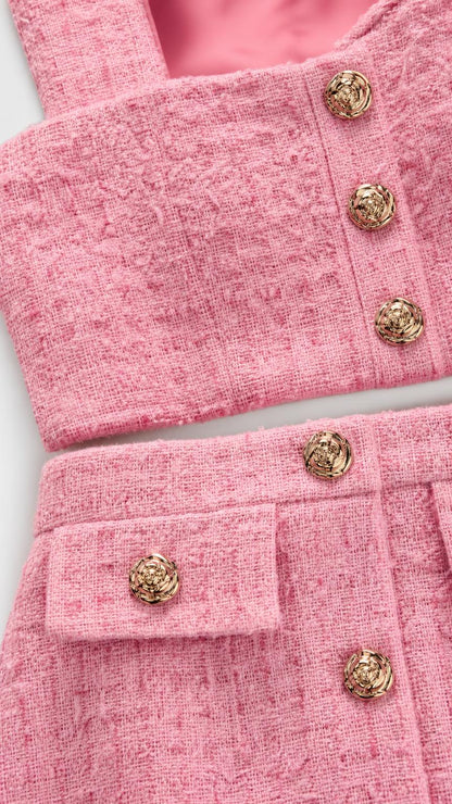 Close up of pink tweed texture and metallic buttons
