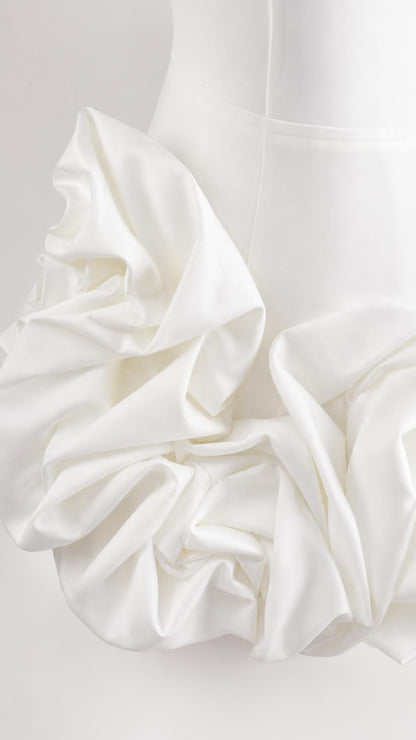 Close-up of dimensional fabric rosette texture on white fabric
