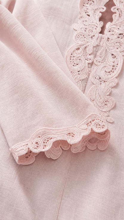 Close-up detail of delicate crocheted lace trim on sleeve and collar