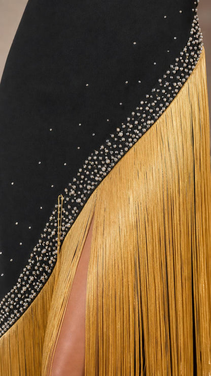 Close up of rhinestone and gold fringe detail on dress