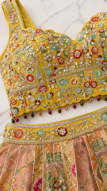 Close-up detail of the heavily embellished yellow blouse and skirt waistband