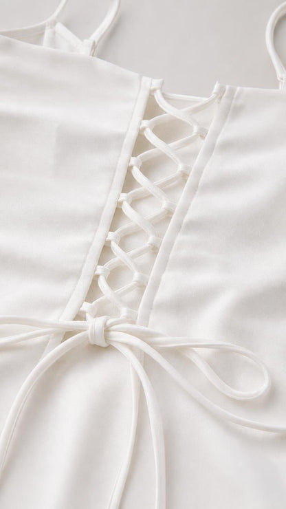 Close-up detail of lace-up back tie on the white cami top
