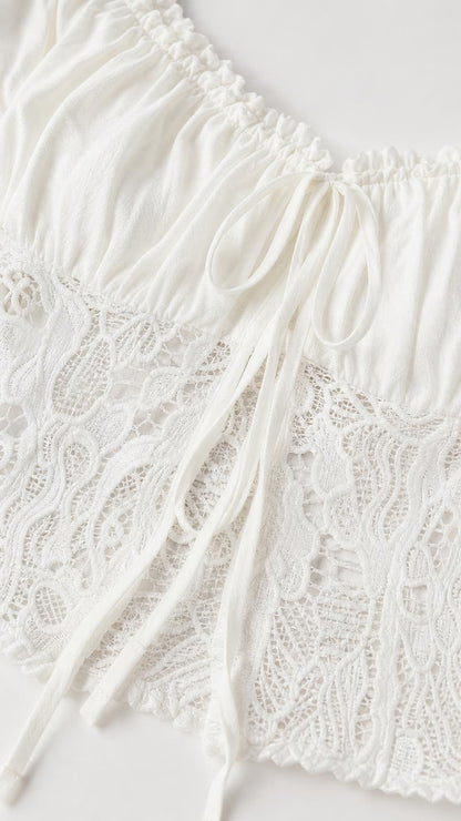 Close-up detail of white crop top lace and drawstring