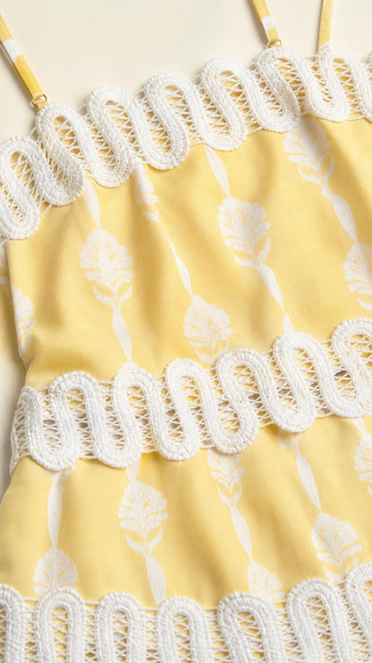 Close-up detail of yellow dress fabric and crochet trim