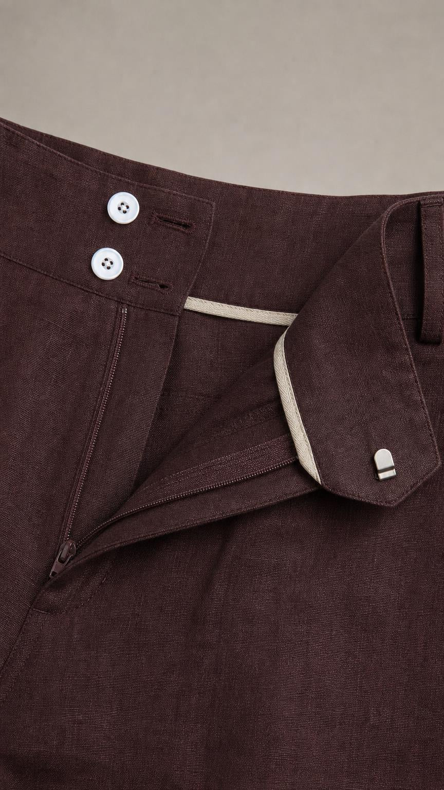 Close-up detail of the trouser waistband and button closure
