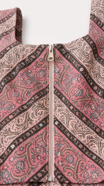 Close-up of zip front detail on paisley top