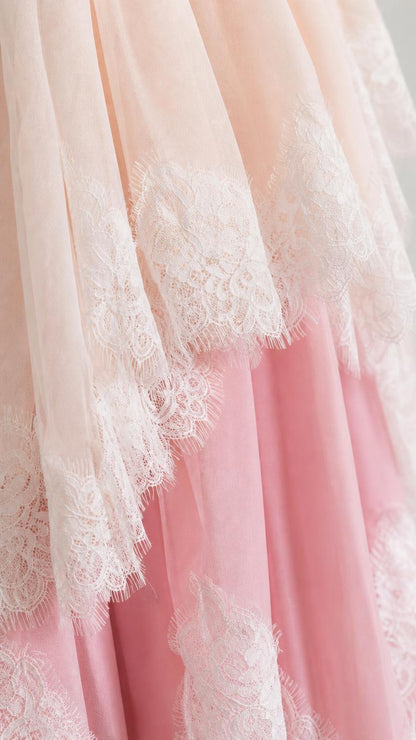 Close-up detail of lace trim on pink and cream tulle layers