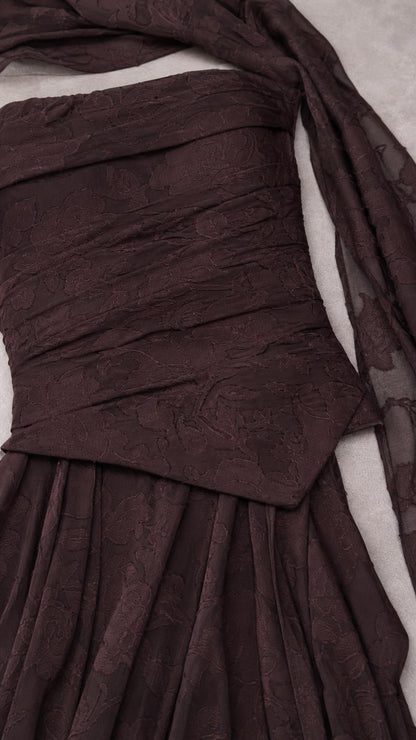 Close-up of textured bodice ruching and asymmetric waist on espresso brown dress