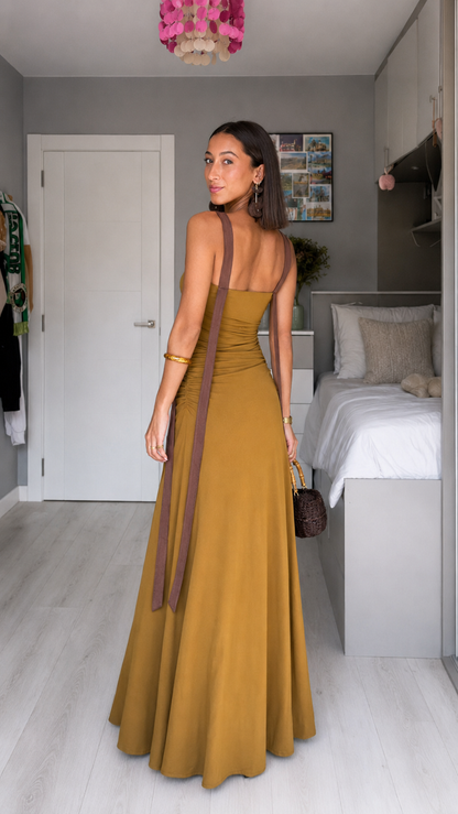 Back view of mustard maxi dress with long contrast straps and fitted bodice