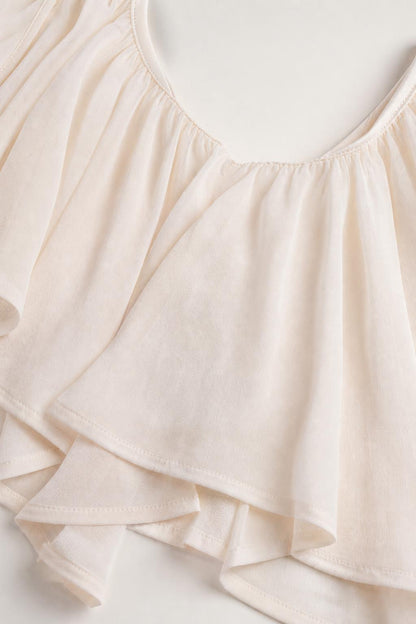 Close-up detail of soft fabric and ruffle trim