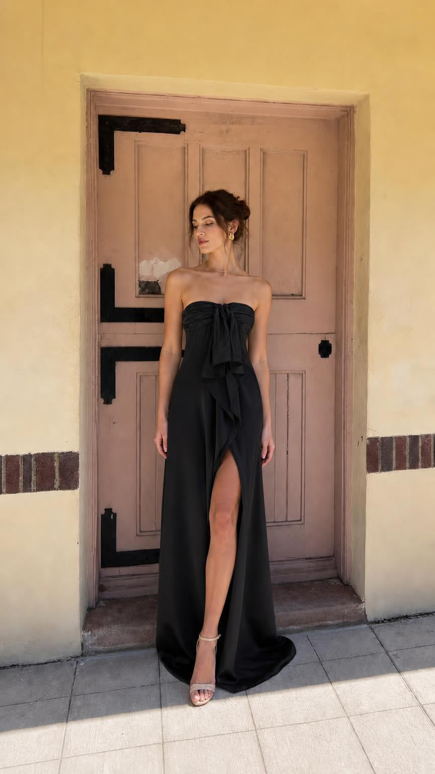 Black strapless evening dress with front bow and high slit