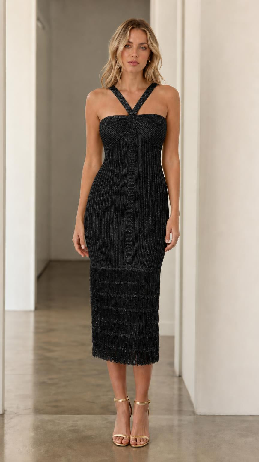 Model wearing black halter fringe midi dress, front view