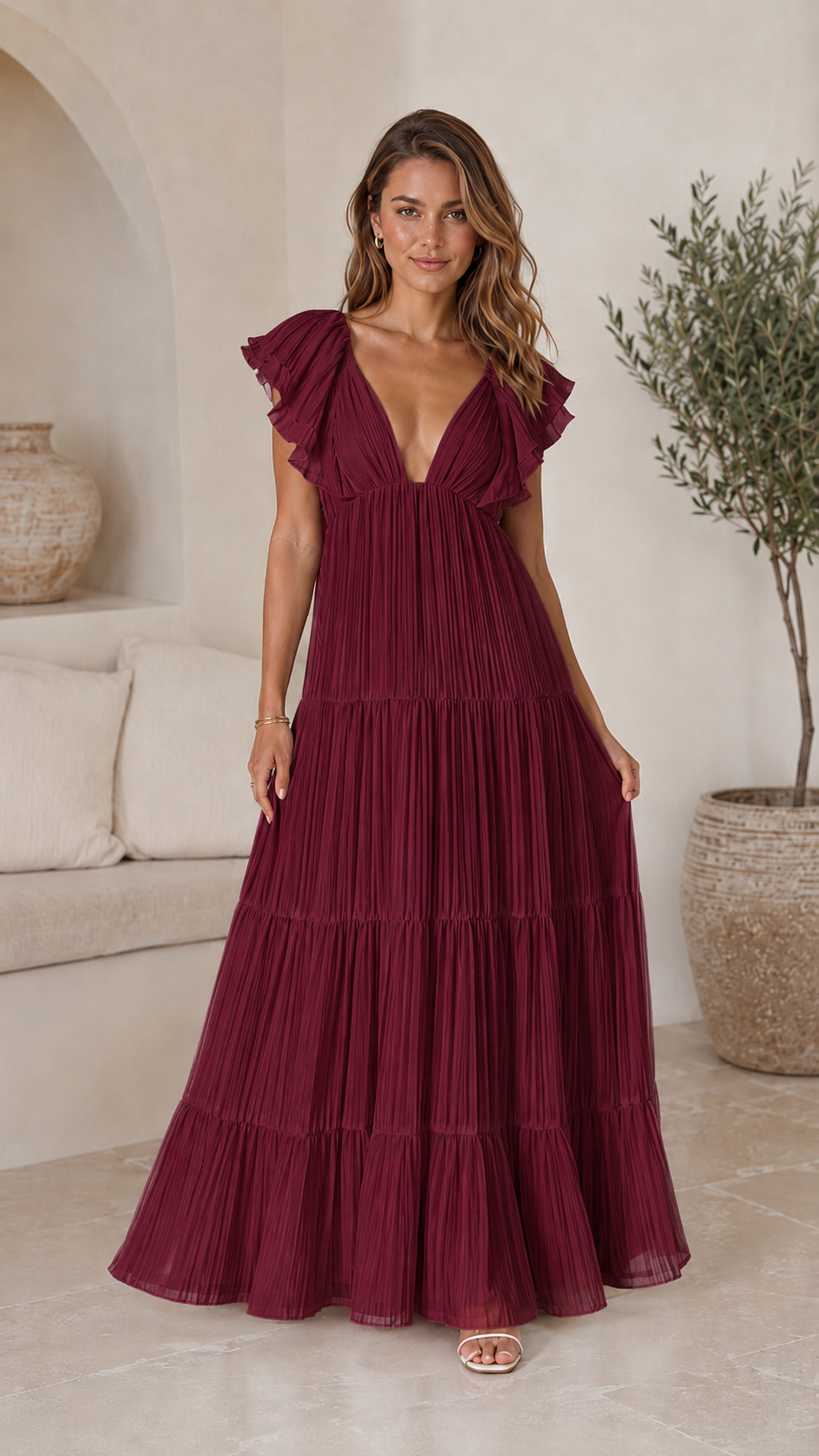 Full front view of burgundy pleated tiered maxi dress with deep V neckline