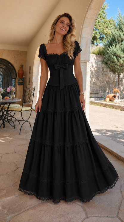 Front view of black lace trim bow front tiered maxi dress