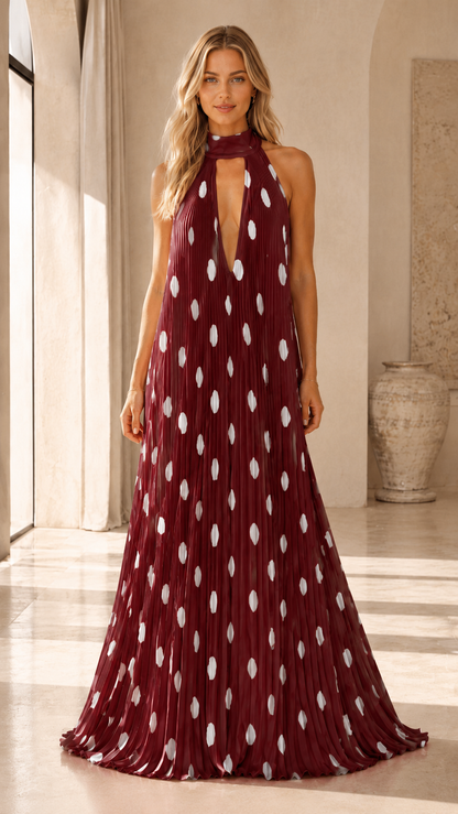 Burgundy pleated halter maxi dress with deep V neckline and white dot pattern front view