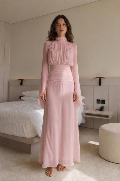 Front view of woman wearing blush pink pleated maxi dress